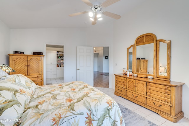 bedroom with ceiling fan, light tile patterned floors, and vaulted ceiling