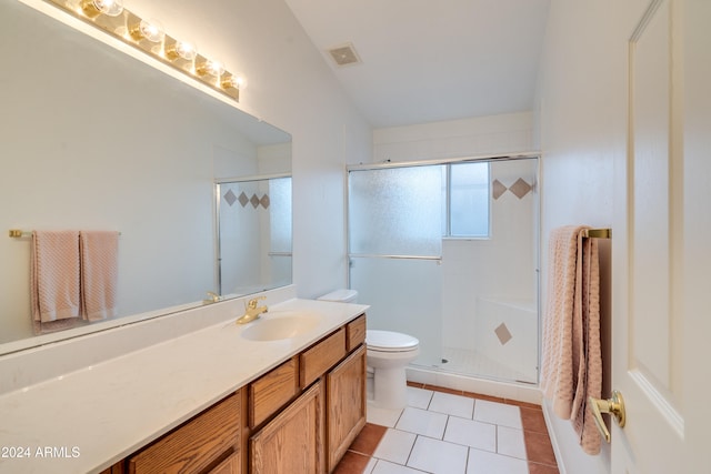 bathroom featuring tile patterned flooring, vanity, toilet, and an enclosed shower