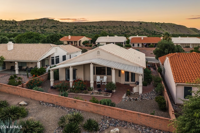 view of front facade with a mountain view and a patio