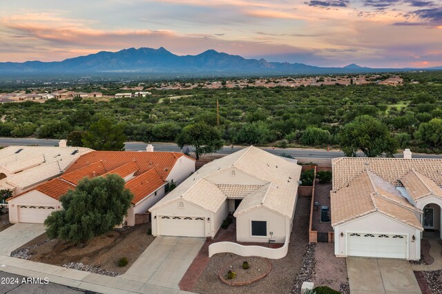 aerial view at dusk featuring a mountain view