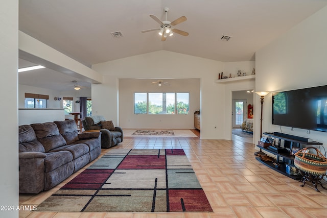 living room featuring a healthy amount of sunlight and lofted ceiling