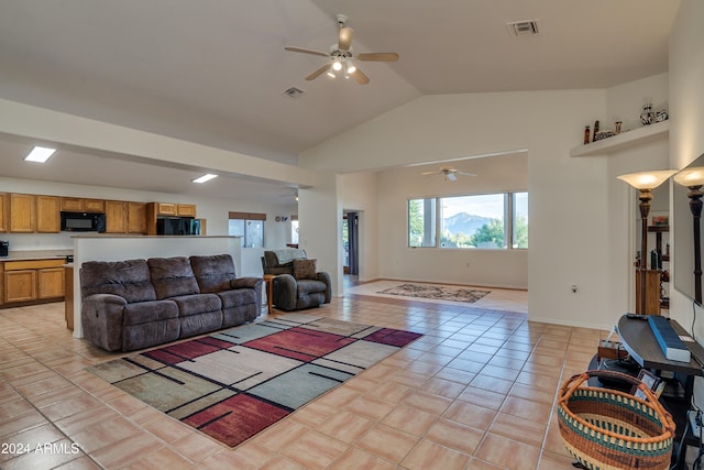 living room featuring ceiling fan, light tile patterned floors, and high vaulted ceiling