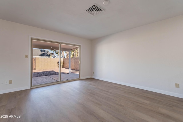 spare room with hardwood / wood-style floors