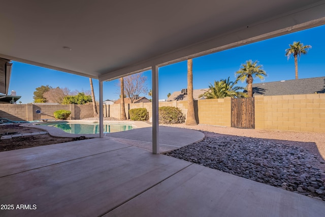 view of patio / terrace with a fenced in pool