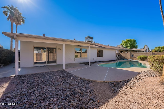 back of house with a patio area and a fenced in pool