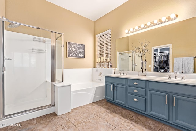 bathroom with shower with separate bathtub, tile patterned flooring, and vanity