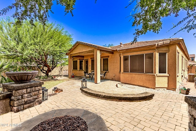 rear view of house featuring a patio