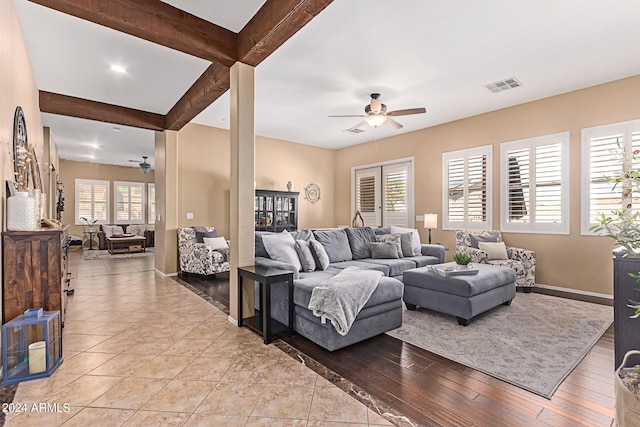 living room with ceiling fan, beamed ceiling, light hardwood / wood-style flooring, and plenty of natural light