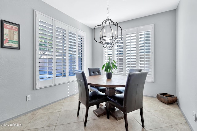 dining area with a chandelier and light tile patterned flooring