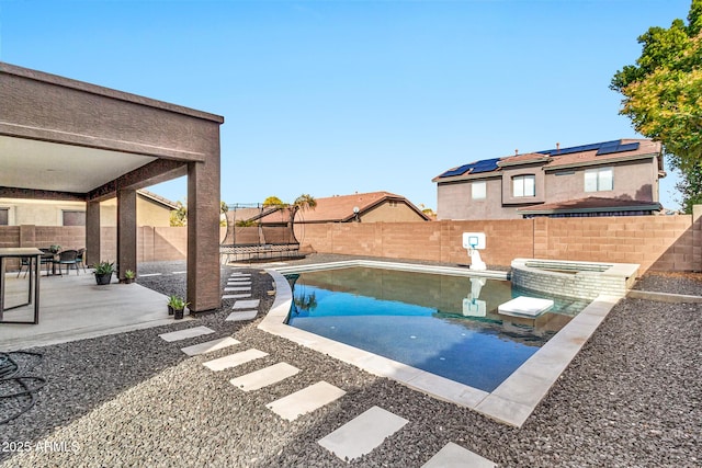 view of pool featuring an in ground hot tub and a patio area