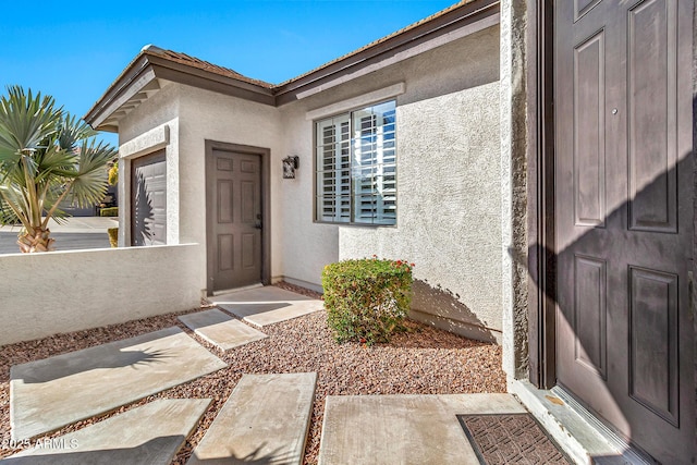 doorway to property featuring a garage