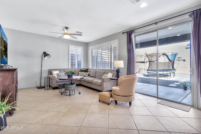 living room with ceiling fan and light tile patterned floors