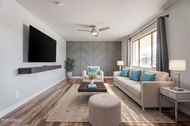 living room with ceiling fan and wood-type flooring