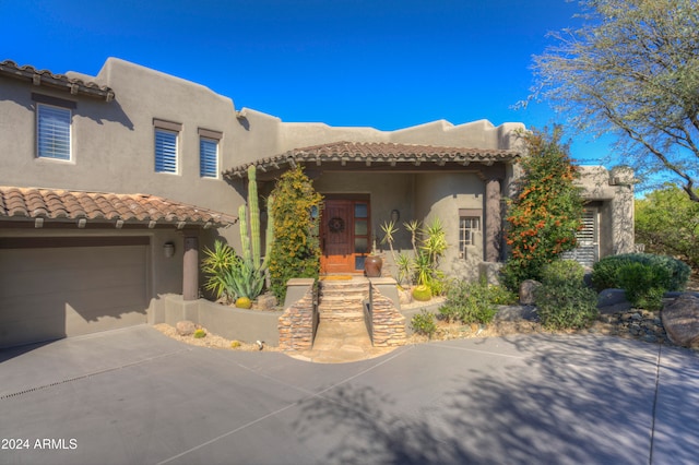 pueblo-style house with a garage