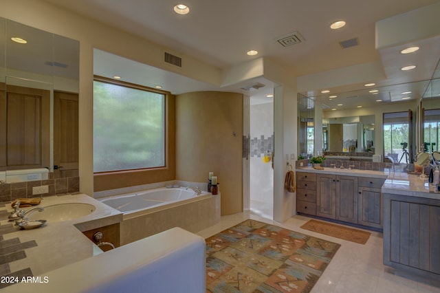 bathroom featuring tile patterned flooring, vanity, and plus walk in shower