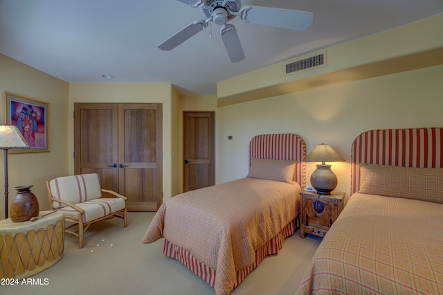 bedroom featuring light colored carpet and ceiling fan