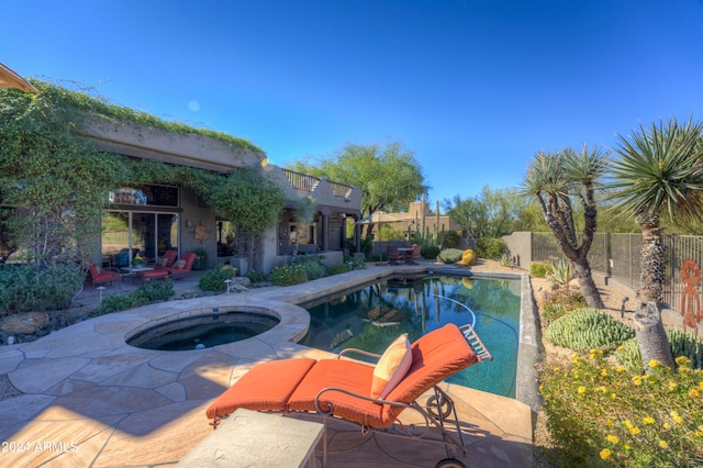 view of pool featuring an in ground hot tub and a patio