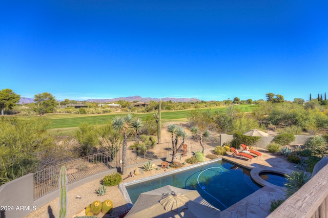 view of swimming pool with a patio area, an in ground hot tub, and a mountain view