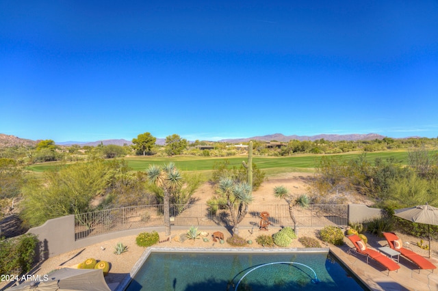 view of swimming pool with a mountain view and a patio area