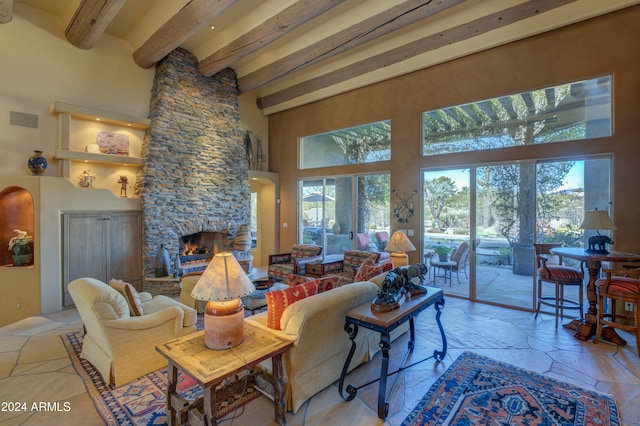 living room featuring french doors, a fireplace, a towering ceiling, and beamed ceiling