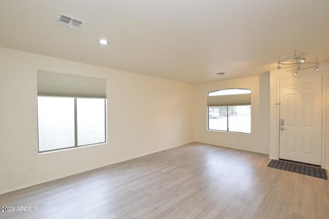 spare room featuring light wood-type flooring