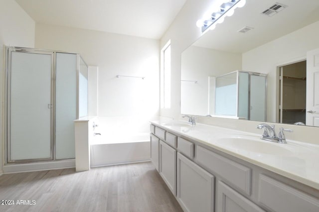 bathroom featuring hardwood / wood-style floors, vanity, and separate shower and tub