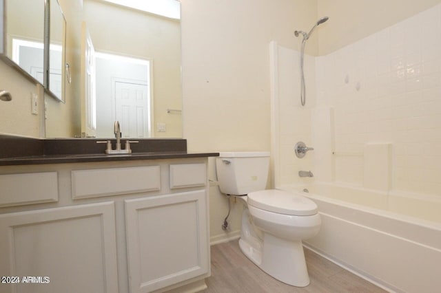 full bathroom featuring bathtub / shower combination, wood-type flooring, vanity, and toilet