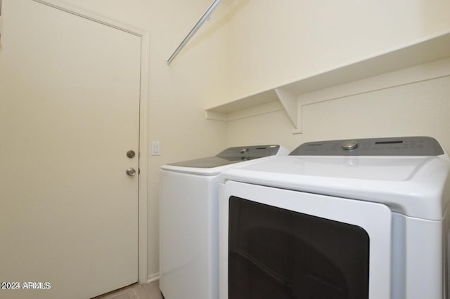 clothes washing area featuring separate washer and dryer