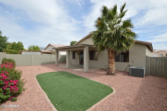 rear view of property with central AC unit and a patio area