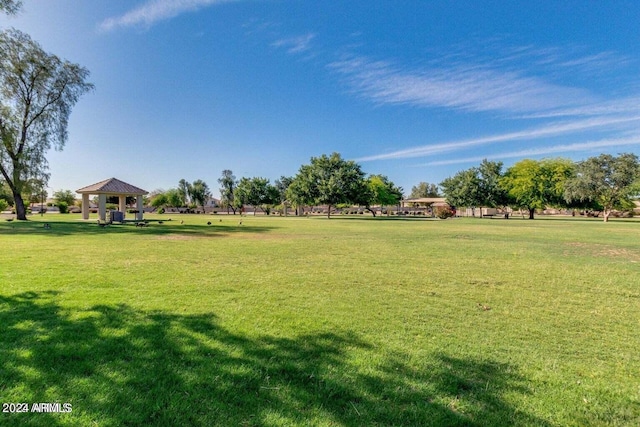 surrounding community with a gazebo and a yard