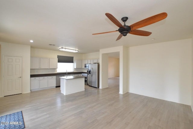 kitchen featuring ceiling fan, a kitchen island, light hardwood / wood-style flooring, white cabinets, and appliances with stainless steel finishes