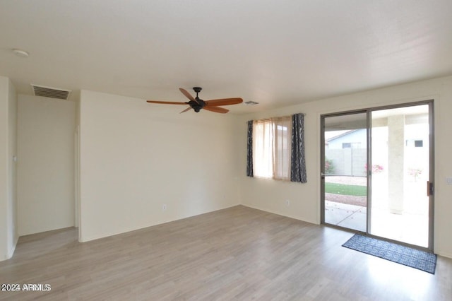 spare room featuring light hardwood / wood-style floors and ceiling fan