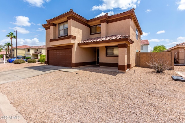 view of front of house featuring stucco siding, fence, a tiled roof, a garage, and concrete driveway