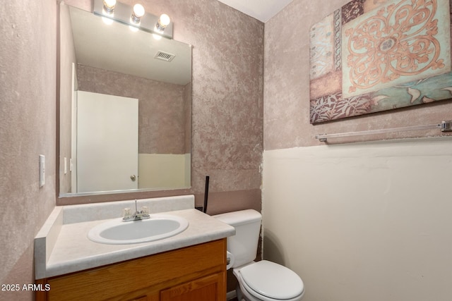 bathroom with toilet and vanity