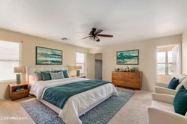 bedroom featuring light colored carpet, multiple windows, and baseboards