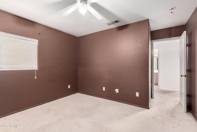 unfurnished room featuring a ceiling fan and carpet