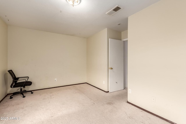 carpeted spare room featuring baseboards