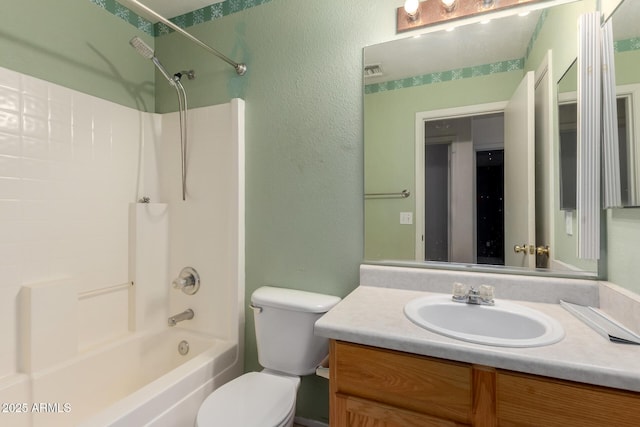bathroom featuring vanity, toilet, washtub / shower combination, and a textured wall