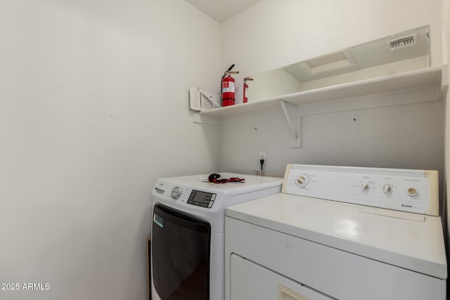 clothes washing area featuring washing machine and dryer