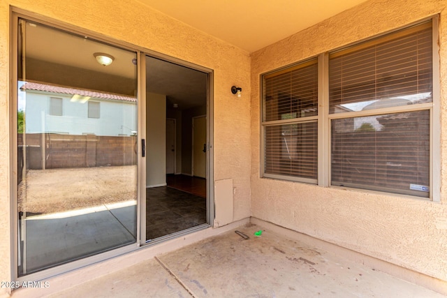view of exterior entry with stucco siding