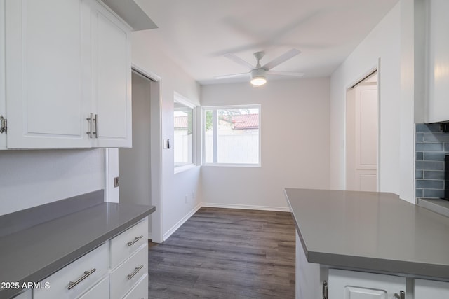 kitchen featuring ceiling fan, white cabinetry, and dark wood-type flooring