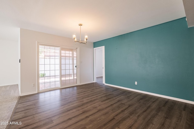 unfurnished room featuring dark hardwood / wood-style floors and a notable chandelier