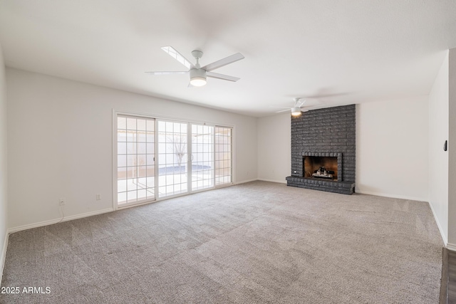 unfurnished living room with a brick fireplace, carpet flooring, and ceiling fan