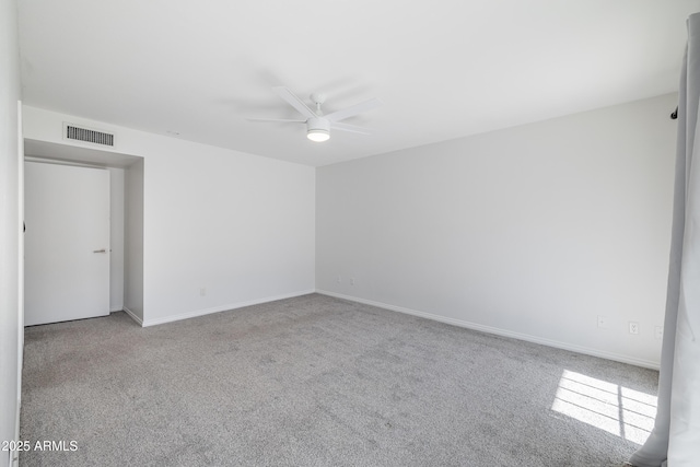 empty room with light colored carpet and ceiling fan