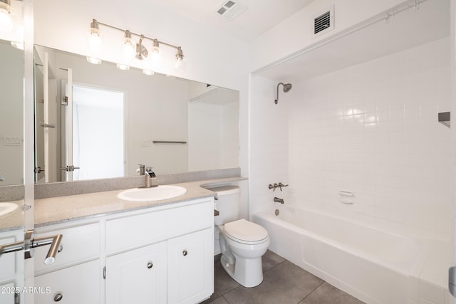 full bathroom with tile patterned floors, toilet, vanity, and tiled shower / bath