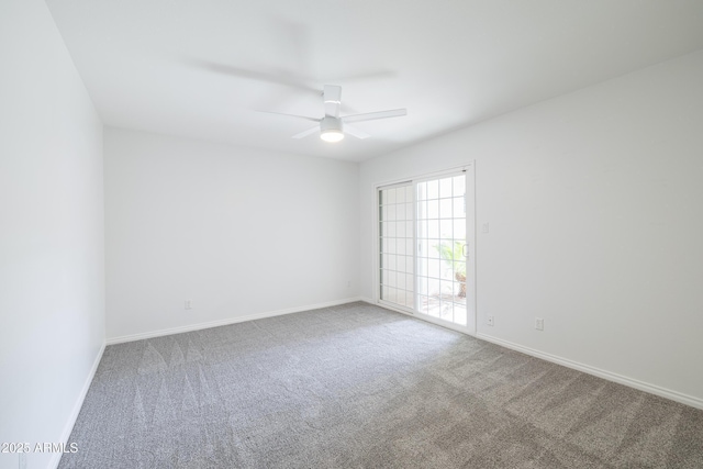 carpeted spare room featuring ceiling fan