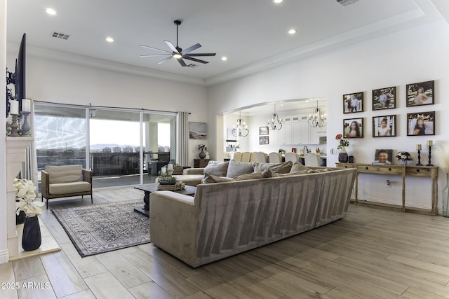 living room with recessed lighting, visible vents, wood finished floors, and ceiling fan with notable chandelier