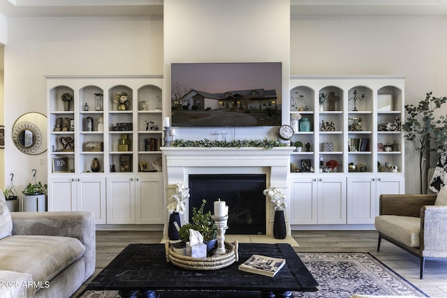 living room with a fireplace with flush hearth and light wood finished floors