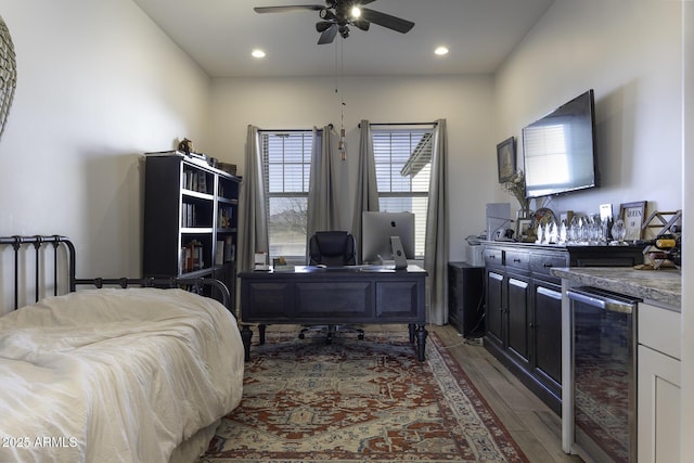 bedroom featuring beverage cooler, recessed lighting, light wood-style flooring, and a dry bar