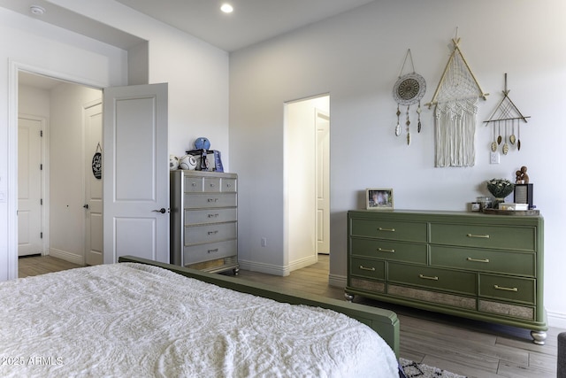 bedroom with baseboards and wood finished floors